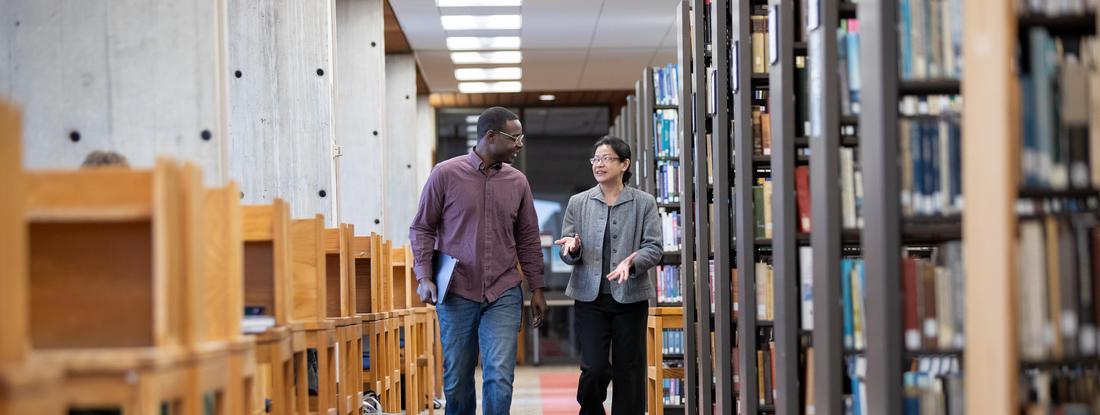 뿪¼ Student and Professor walking in Bush library